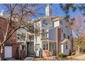 Well-maintained condo exterior with brick accents and mature trees at 5550 W 80Th Pl # 23, Arvada, CO 80003