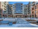 Modern apartment complex showcasing brick and stone accents, complemented by a landscaped entrance at 20 Wilcox St # 316, Castle Rock, CO 80104