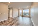 Bright living room featuring modern hardwood floors, ample natural light, and neutral wall colors at 20 Wilcox St # 316, Castle Rock, CO 80104