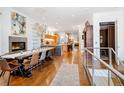 Open concept dining room with hardwood floors and large farmhouse table at 402 Garfield St, Denver, CO 80206