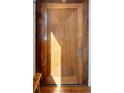 Intricate wood entry door with unique vertical carvings adds curb appeal at 402 Garfield St, Denver, CO 80206