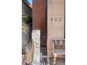 Modern home exterior with brick accents, water feature, and bench at 402 Garfield St, Denver, CO 80206