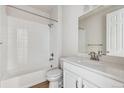 Clean bathroom with white tile and modern vanity at 3254 Boral Owl Dr, Brighton, CO 80601