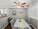 Dining room with a gray table and chairs, a bar cart, and a ceiling fan at 8199 Welby Rd # 1102, Denver, CO 80229