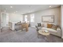 Cozy and neutral loft area with sofa, desk, chair, decorative pillows, and natural light at 23731 E 40Th Ave, Aurora, CO 80019