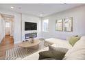 Inviting living room with a large sofa, modern fireplace, and contemporary decor at 23731 E 40Th Ave, Aurora, CO 80019