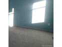 Bright bedroom with light teal walls and neutral carpeting at 1153 Elbridge Dr, Elizabeth, CO 80107