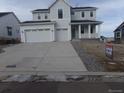 Two-story home with gray siding, three-car garage, and a paved driveway at 1153 Elbridge Dr, Elizabeth, CO 80107