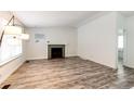 Bright living room with stylish wood-look floors, fireplace, and modern lighting at 4274 S Fundy Way, Aurora, CO 80013