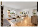 Bright living room with hardwood floors, fireplace, and large windows offering natural light at 797 W Briarwood Ave, Littleton, CO 80120