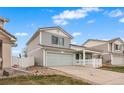 A side view of a well-maintained two-story home features a two-car garage and tidy landscaping at 20414 E 55Th Pl, Denver, CO 80249
