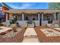 Charming bungalow with a landscaped front yard and inviting covered porch at 2955 N Columbine St, Denver, CO 80205