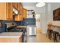 Functional kitchen with stainless steel appliances, ample cabinet space and bar seating at 2955 N Columbine St, Denver, CO 80205