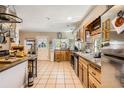 Open kitchen with tile flooring, stainless appliances, and a functional layout at 33 L Rd, Golden, CO 80403