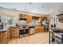 Bright kitchen featuring stainless steel appliances, tile countertops, and ample cabinet space at 33 L Rd, Golden, CO 80403