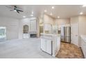 Spacious living area with an open layout, breakfast bar, and stainless steel appliances at 3845 Miller St, Wheat Ridge, CO 80033