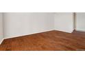 Bright living room featuring hardwood floors and a landing to another room at 6946 W Alaska Dr, Lakewood, CO 80226