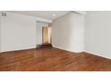 A bright living room with hardwood floors and an entry door off of a small landing at 6946 W Alaska Dr, Lakewood, CO 80226