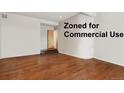 Open-concept living room with hardwood flooring, and staircase at 6946 W Alaska Dr, Lakewood, CO 80226