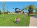 Modern two-story building with a stylish design, outdoor seating area and sign for a fun run at 15295 W 68Th Pl, Arvada, CO 80007