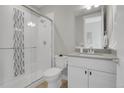 Modern bathroom with a walk-in shower and white vanity at 6025 Ames St # A, Arvada, CO 80003