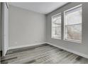 Bright bedroom with gray walls and gray laminate flooring at 6025 Ames St # A, Arvada, CO 80003