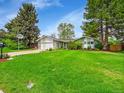 Charming single Gathering home with stone accents, a two-car garage, and a well-manicured front yard at 461 Nome St, Aurora, CO 80010