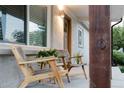 Inviting front porch featuring two chairs and plants, perfect for relaxing and enjoying the neighborhood views at 2257 S Lowell Blvd, Denver, CO 80219