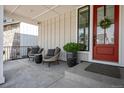 Inviting front porch with seating and charming red door with wreath detail at 11053 Bright Sky Cir, Littleton, CO 80125