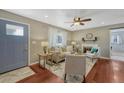 Cozy living room with hardwood floors, a ceiling fan, and abundant natural light at 8325 Elati St, Denver, CO 80221
