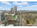 Aerial view showcasing the property's location along a parkway with the downtown city skyline in the background at 3132 E 17Th Ave # B, Denver, CO 80206