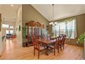 Formal dining room with hardwood floors, chandelier, and space for a large dining table at 6699 S Robb St, Littleton, CO 80127