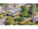 Backyard aerial view showcasing a spacious yard with mature trees and a wooden deck at 10429 Quivas St, Northglenn, CO 80234