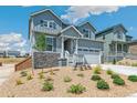 Stylish two-story home featuring stone accents, a two-car garage, and manicured landscaping at 1871 Water Birch Way, Castle Rock, CO 80108