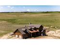 Aerial view of a home on expansive land with mountain views, showcasing the property's privacy and scenic location at 2710 Rustlers Canyon Loop, Elizabeth, CO 80107