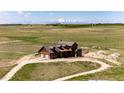 Aerial view of a home with surrounding landscapes, highlighting its secluded location and long winding driveway at 2710 Rustlers Canyon Loop, Elizabeth, CO 80107