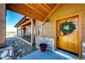Charming entryway with a wooden door adorned with a festive wreath and stonework at 2710 Rustlers Canyon Loop, Elizabeth, CO 80107