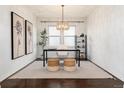Bright and airy office features a modern desk, decor, stylish light fixture and hardwood flooring at 16549 Prospect Ln, Broomfield, CO 80023