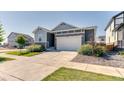 Inviting home with a well-maintained lawn and a spacious driveway leading to an attached garage at 4776 Kipp Pl, Brighton, CO 80601