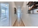 Bright hallway with hardwood floors and modern decor, leading to a well-lit room at 4776 Kipp Pl, Brighton, CO 80601