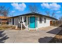 Well-maintained one story home with eye-catching blue door and manicured landscaping at 1270 S Lowell Blvd, Denver, CO 80219