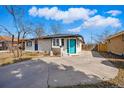 Bright and modern single-story home featuring a new concrete driveway and freshly painted exterior at 1270 S Lowell Blvd, Denver, CO 80219