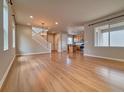 Bright and airy living room with wood floors and staircase at 8018 Williams Fork Ave, Littleton, CO 80125