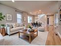 Cozy living room area with neutral colors, comfortable seating, and a view of the staircase at 8018 Williams Fork Ave, Littleton, CO 80125