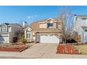 Attractive two-story home with well-maintained landscaping, two car garage, and inviting curb appeal at 20349 E Powers Pl, Centennial, CO 80015