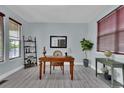 Bright home office with ample natural light, stylish desk, and decor at 11670 S Flower Mound Way, Parker, CO 80134
