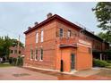 Corner view of the charming brick building showcasing its unique architectural details and classic design at 2801 Champa St, Denver, CO 80205
