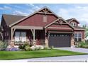 Charming two-story home featuring a symmetrical facade, stylish design elements, and professional landscaping at 14115 Blue Stem St, Broomfield, CO 80020
