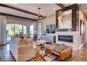 Cozy living room featuring a fireplace, modern decor, and seamlessly flowing to the outdoors at 14115 Blue Stem St, Broomfield, CO 80020