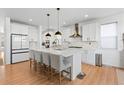 Spacious, modern kitchen with white cabinets, a large island, and stainless steel appliances at 12841 Galapago St, Westminster, CO 80234